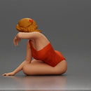 attractive woman in red swimsuit resting calmly on the beach - Only-Games