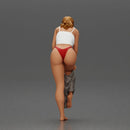 Woman in white top carefully wearing grey pants with balance - Only-Games