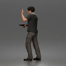 Man Standing With Handgun And Peace Sign In T-Shirt Scarf Cargo Pants And Boots