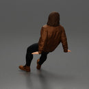 Man with long hair wearing brown jacket sitting with relaxed posture - Only-Games