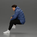 Street performer crouching low in blue puffer jacket athletic stance sitting - Only-Games