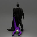 Batman dragging Joker by leg after defeating him in battle - Only-Games