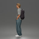Student standing with backpack wearing oversized tee and baggy jeans