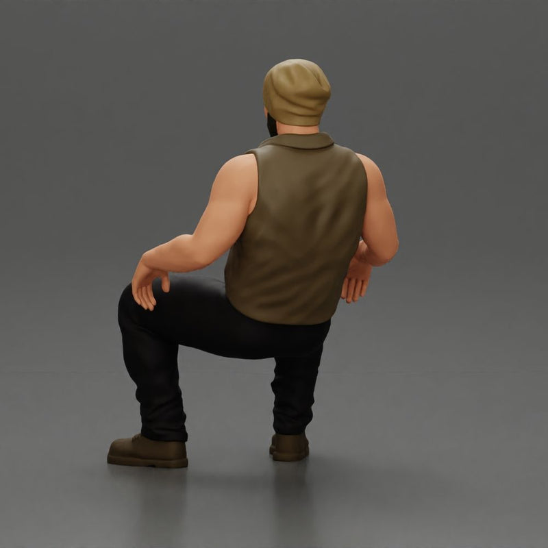 Muscular Bearded Man in Beanie Vest Pants Sitting Casually Relaxed - Only-Games