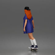 Skateboard girl in long shirt and cap gliding smoothly forward in relaxed street style pose - Only-Games