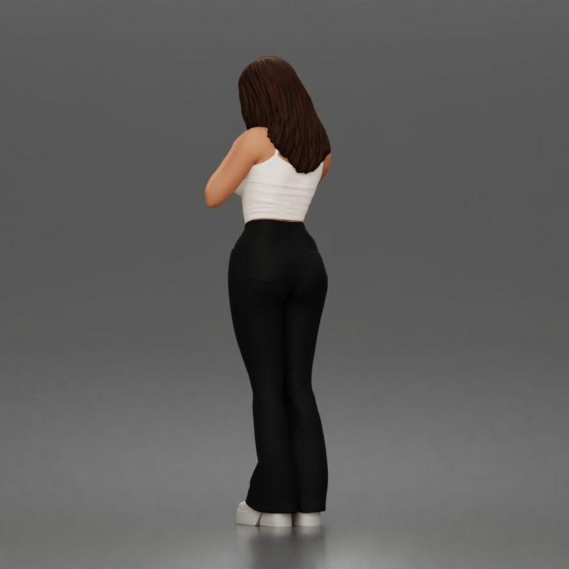 Thoughtful woman stands daydreaming wearing crop tank top and trousers - Only-Games