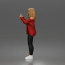 woman pointing upward wearing off shoulder shirt leggings sneakers