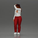 woman in red pants striking stylish pose with hat - Only-Games