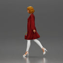 Woman with curly hair wearing red coat walking holding red handbag - Only-Games