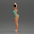 Brunette woman in turquoise swimsuit stretching with elegant ballet pose - Only-Games
