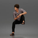 Man Sitting With Knee Bent In Shirt Trousers And Sandals