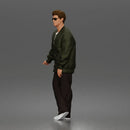 Man standing In Bomber Jacket Tee Trousers Sneakers And Sunglasses