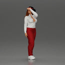 woman in red pants striking stylish pose with hat - Only-Games