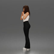 Thoughtful woman stands daydreaming wearing crop tank top and trousers - Only-Games