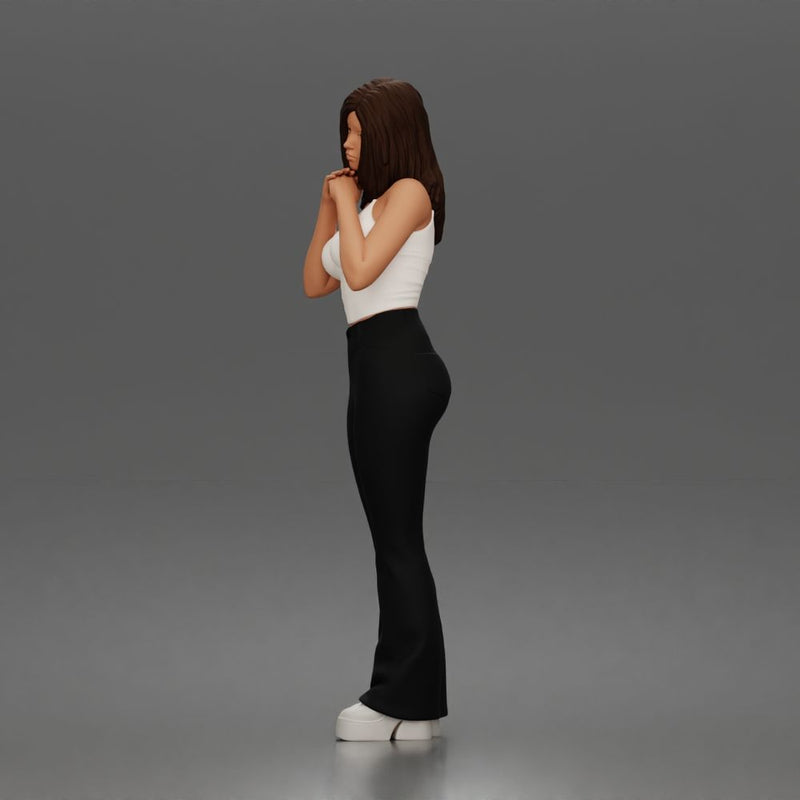 Thoughtful woman stands daydreaming wearing crop tank top and trousers - Only-Games