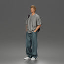 Student standing with backpack wearing oversized tee and baggy jeans