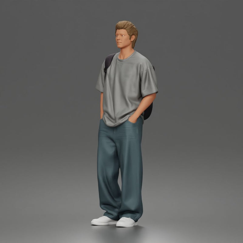 Student standing with backpack wearing oversized tee and baggy jeans