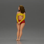 Woman in yellow top and red shorts leaning to wall - Only-Games