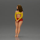 Woman in yellow top and red shorts leaning to wall - Only-Games