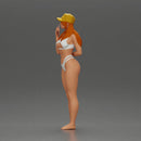 girl in a white bikini holding a phone on the beach and wearing a cap - Only-Games