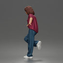 Girl Leaning posing against wall in pocket tee and denim