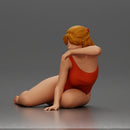 attractive woman in red swimsuit resting calmly on the beach - Only-Games