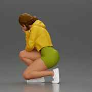 Performer crouching thoughtfully in yellow jacket green shorts white sneakers - Only-Games