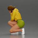 Performer crouching thoughtfully in yellow jacket green shorts white sneakers - Only-Games