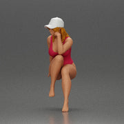 Woman in Swimsuit and Cap Sitting Thoughtfully in Relaxed Pose - Only-Games