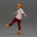 Woman in casual outfit joyfully kicks her leg with energy - Only-Games