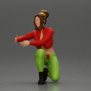 Fashionable woman kneeling in red jacket, green pants, and black boots - Only-Games