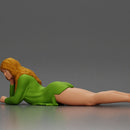 Girl with long hair in green dress lying with calm on the beach - Only-Games