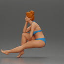 Woman sitting in Blue Bikini Ponders with Relaxed Posture - Only-Games