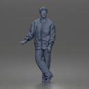 Man standing In Bomber Jacket Tee Trousers Sneakers And Sunglasses