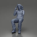 Man sitting with gun in hand pointing forward calmly - Only-Games