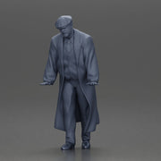 Man in black coat wearing flat cap standing with serious expression - Only-Games