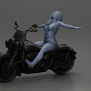 Woman in red outfit stretching arms wide while sitting on motorcycle - Only-Games
