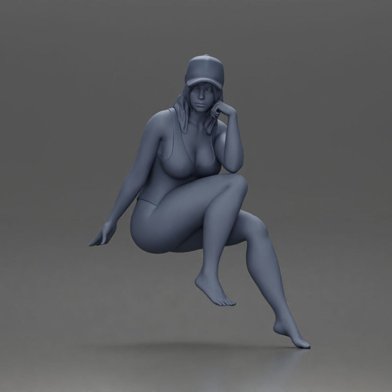 Woman in Swimsuit and Cap Sitting Thoughtfully in Relaxed Pose - Only-Games