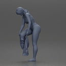 Woman in white top carefully wearing grey pants with balance - Only-Games