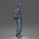 Student standing with backpack wearing oversized tee and baggy jeans