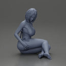 Woman in green bikini sitting gracefully on the floor with a relaxed pose - Only-Games