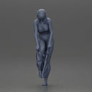 Woman in white top carefully wearing grey pants with balance - Only-Games