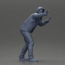 Man in hoodie pointing gun while raising hand in defensive gesture - Only-Games