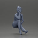 Woman sitting in Blue Bikini Ponders with Relaxed Posture - Only-Games