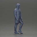 Man in brown coat glances sideways dressed in stylish winterwear - Only-Games