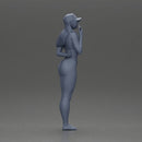 girl in a white bikini holding a phone on the beach and wearing a cap - Only-Games