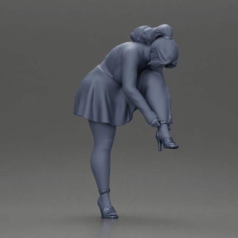 Young woman in skirt adjusts her elegant black high heeled shoes - Only-Games