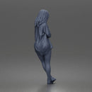 leaning woman folds arms open shirt swimwear bottoms and sneakers