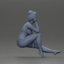 Woman sitting in Blue Bikini Ponders with Relaxed Posture - Only-Games