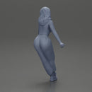 Woman sitting on car in red top yellow pants striking playful pose - Only-Games